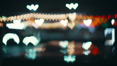 Multicolored lights on the road are blurred in the shape of a heart Stock Footage 231735121