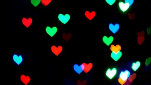 Multicolored lights in the shape of a heart glow in the dark abstract background Stock Footage 84928070
