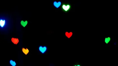 Multicolored lights in the shape of a heart glow in the dark abstract background Stock Footage 85002310