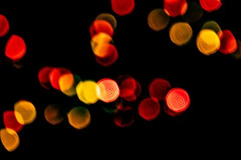 Multicolored lights in soft focus on a black background bokeh Stock Photos