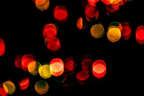 Multicolored lights in soft focus on a black background bokeh Stock Photos