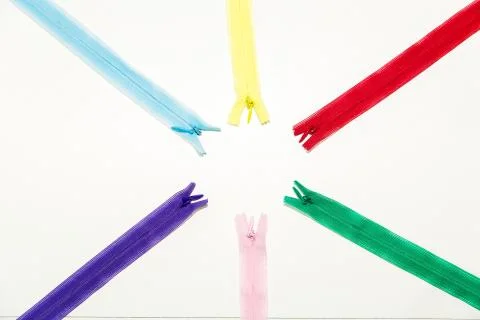 Multicolored locks for clothes lie on the table top view - fittings for needl Stock Photos