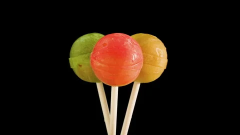 Multicolored lollipops on a black background, sweet candy on a stick. Stock Footage 160448849