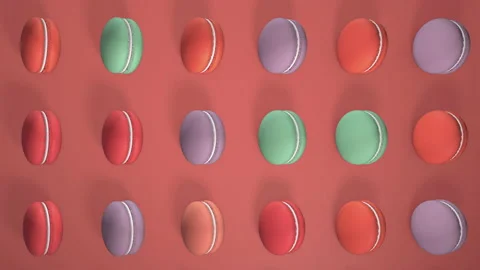 Multicolored macaron pastries photographed on light red paper background. Patter Stock Footage 154932060