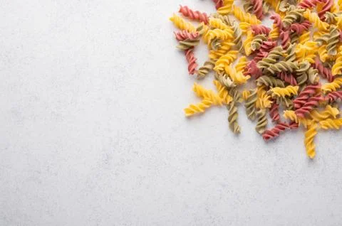 Multicolored macaroni background concept. Diet and healthy food concept. Italian Stock Photos