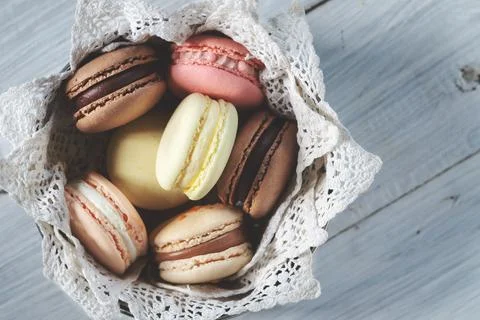 Multicolored macarons in a plate. Top view Stock Photos