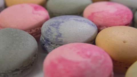 Multicolored macarons, rotate on its axis on a white background. High quality 4k Stock Footage 165562598