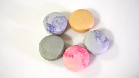 Multicolored macarons, rotate on its axis on a white background. High quality 4k Stock Footage 165564708