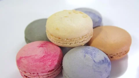 Multicolored macarons, rotate on its axis on a white background. Stock Footage 165564734