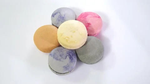 Multicolored macarons, rotate on its axis on a white background. Stock Footage 165564966