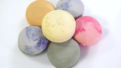 Multicolored macarons, rotate on its axis on a white background. Stock Footage 165566159