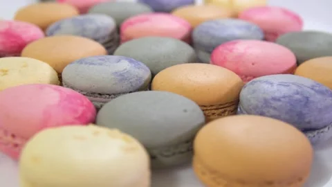 Multicolored macarons, rotate on its axis on a white background. Stock Footage 165566225