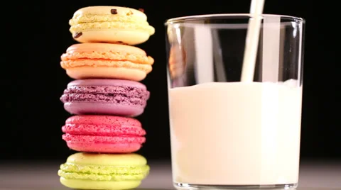 Multicolored macaroon and pouring milk Stock Footage 34381097