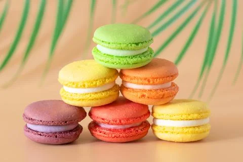 Multicolored macaroons are stacked in a pyramid Stock Photos