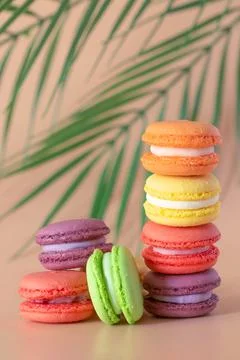 Multicolored macaroons are stacked vertically Stock Photos