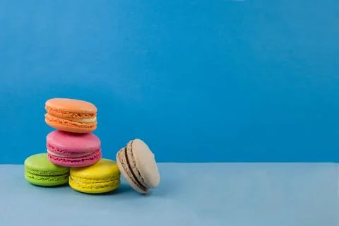 Multicolored macaroons on a blue background 스톡 사진