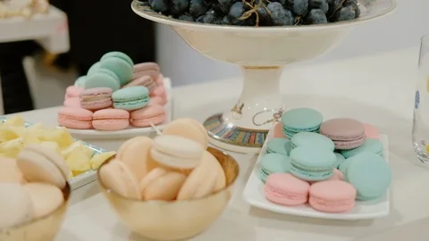 Multicolored macaroons in bowls on the table. Stock Footage 85692079