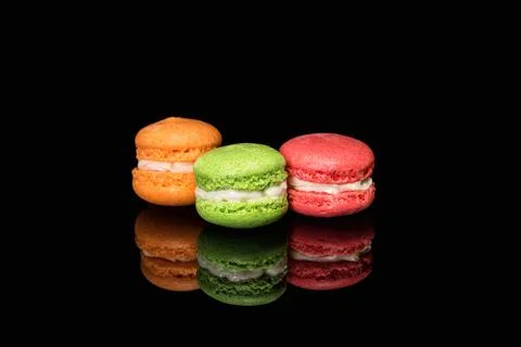 Multicolored macaroons isolated on black background with reflection. Free spa Stock Photos