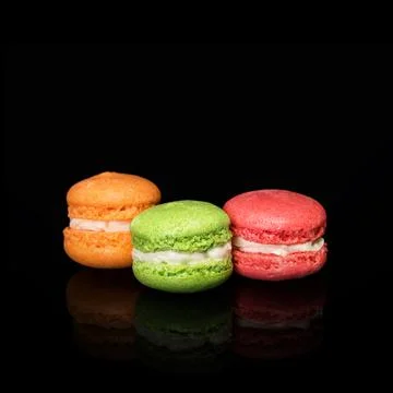Multicolored macaroons isolated on black background with reflection. Free spa Stock Photos