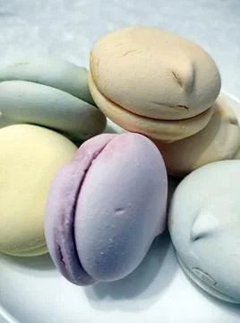 Multicolored macaroons (marshmallows) on a white plate Stock Photos