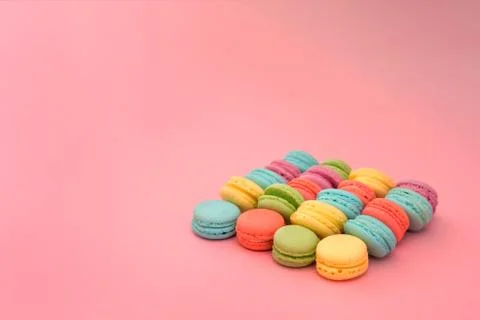 Multicolored macaroons on pink background Stock Photos