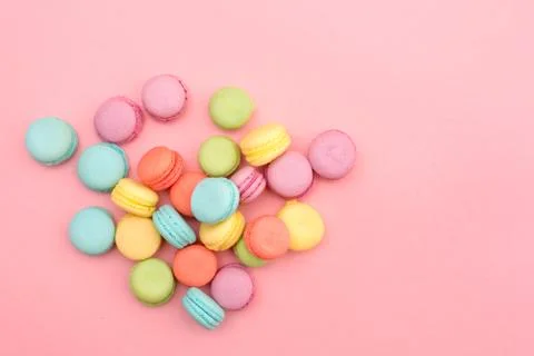 Multicolored macaroons on pink background Stock Photos