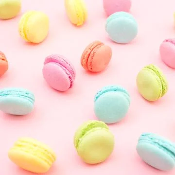 Multicolored macaroons on pink background Stock Photos