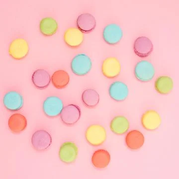 Multicolored macaroons on pink background Stock Photos