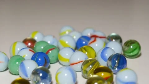 Multicolored marbles on black surface 動画素材 185490136