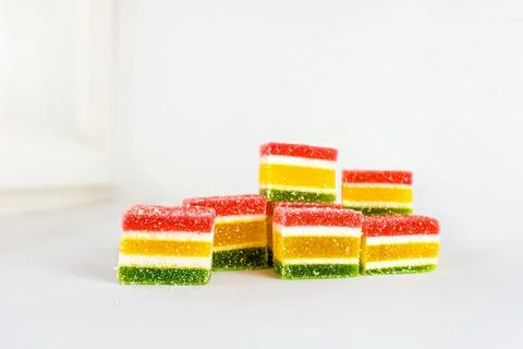 Multicolored marmalade in a stack on a white background Stock Photos