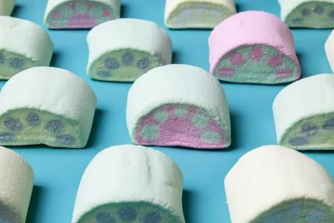 Multicolored marshmallows on a blue background Stock Photos