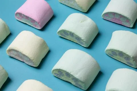 Multicolored marshmallows on a blue background Stock Photos