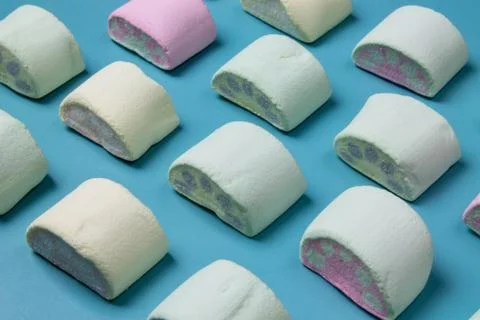 Multicolored marshmallows on a blue background Stock Photos