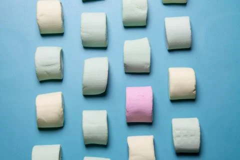Multicolored marshmallows on a blue background Stock Photos