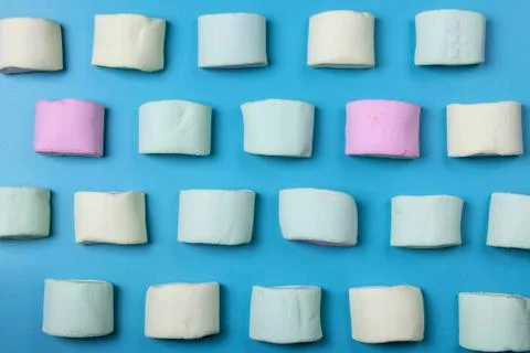 Multicolored marshmallows on a blue background Stock Photos