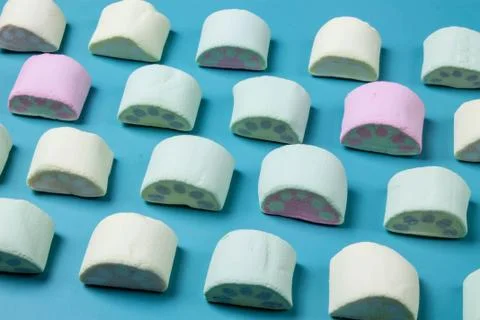 Multicolored marshmallows on a blue background Stock Photos