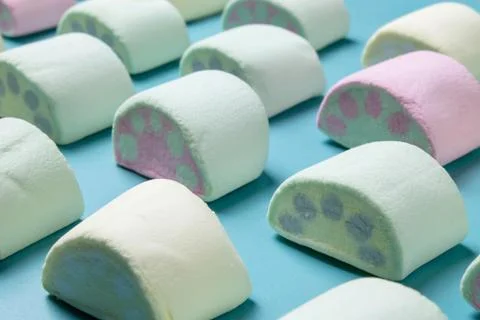 Multicolored marshmallows on a blue background Stock Photos