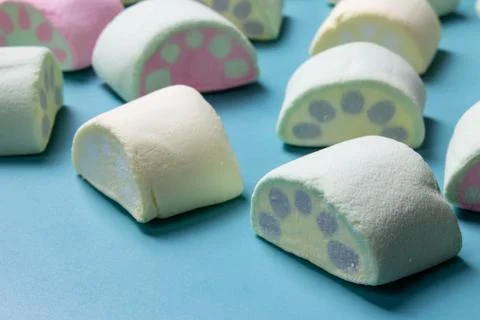 Multicolored marshmallows on a blue background Stock Photos