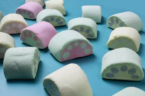 Multicolored marshmallows on a blue background Stock Photos