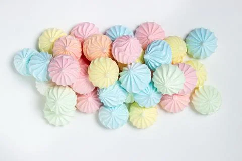 Multicolored meringues on a white background Stock Photos