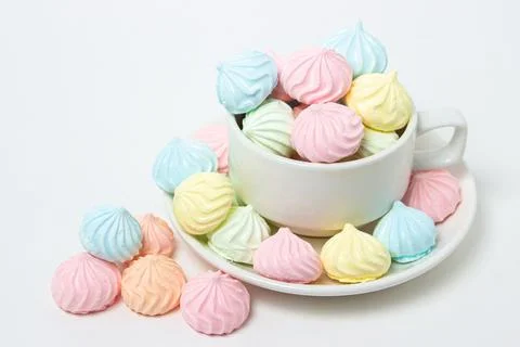 Multicolored meringues on a white background Stock Photos
