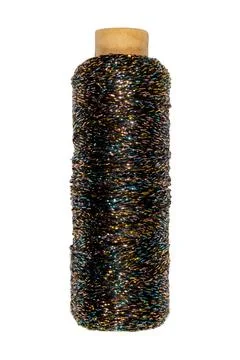 Multicolored metallic embroidery thread spool shimmering iridescent textile.. Stock Photos
