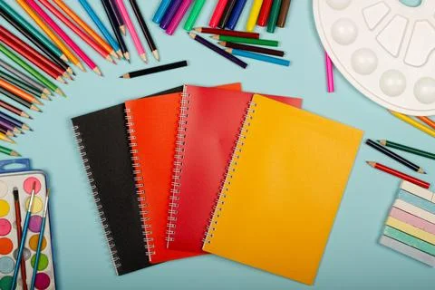 Multicolored notebooks, black, red and orange, art school supplies for painting Stock Photos