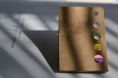 Multicolored notes in the office on the table Stock Photos