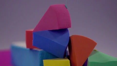 A multicolored paint drips onto the pyramid from the sponge for make-up. Stock Footage 77512077