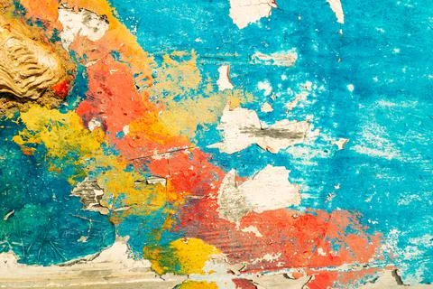 Multicolored paint on an old cracked surface. Grunge style, creative design.  Stock Photos