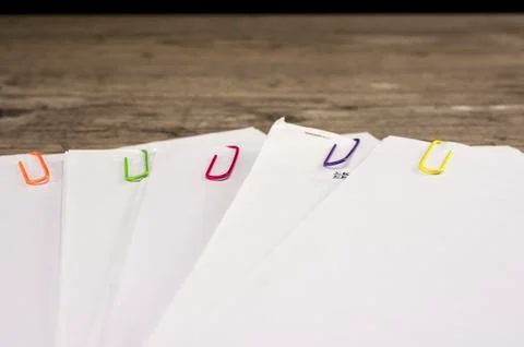 Multicolored paper clips on paperwork Stock Photos