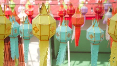 Multicolored paper lanterns hang in rows during daylight Stock Footage 301754860