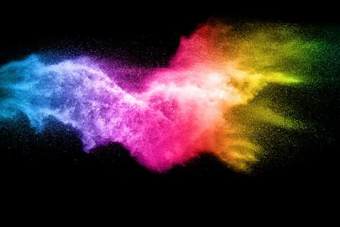 Multicolored particles explosion on white background. Colorful dust splatter. Stock Photos