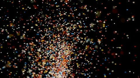 Multicolored particles fly rainbow sprinkles bouncing falling down black Stock Footage 106733183